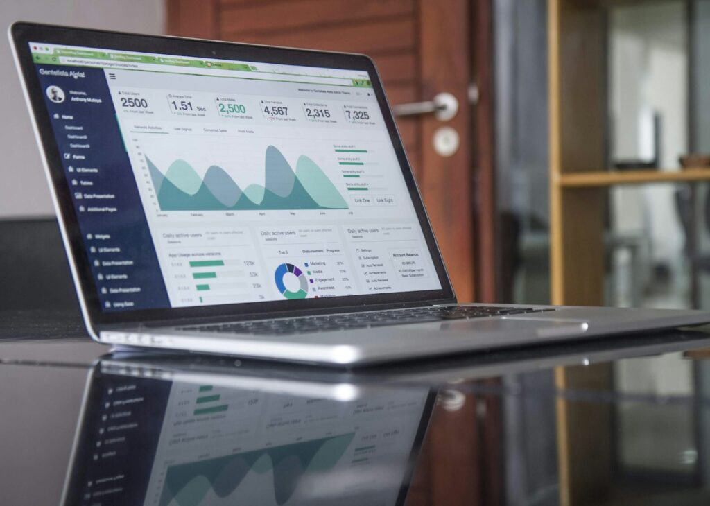 Laptop showing custom business reports and charts